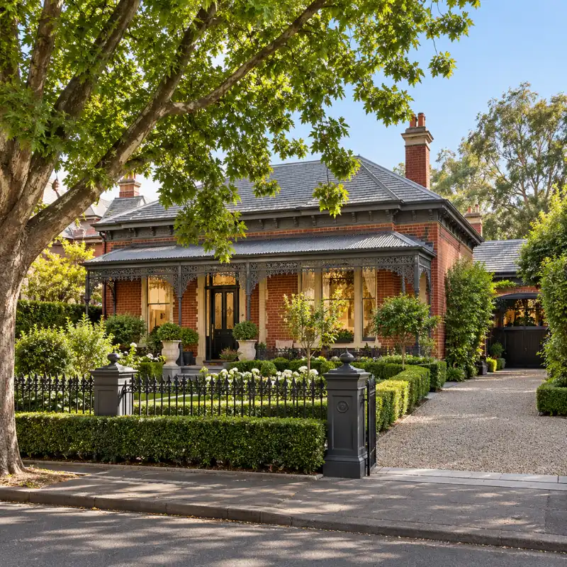 Red-brick period home in Hawthorn with established garden, wrought-iron fence and wide driveway
